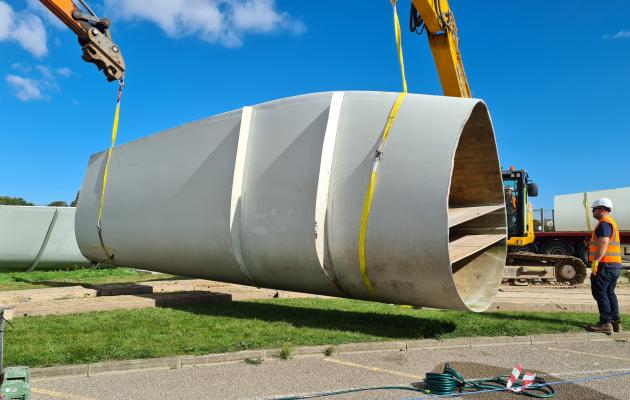 Decommissioned wind turbine blade segment being loaded